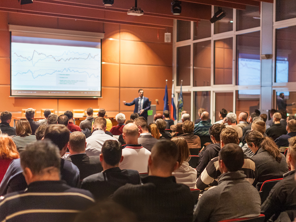 Speaker at podium addressing audience