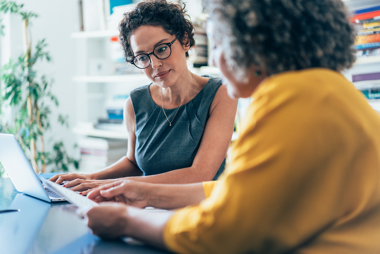 Two individuals reviewing documentation