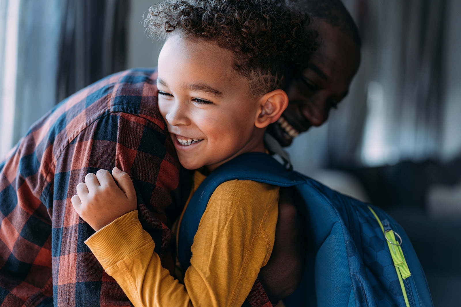 A school child hugging a parental figure